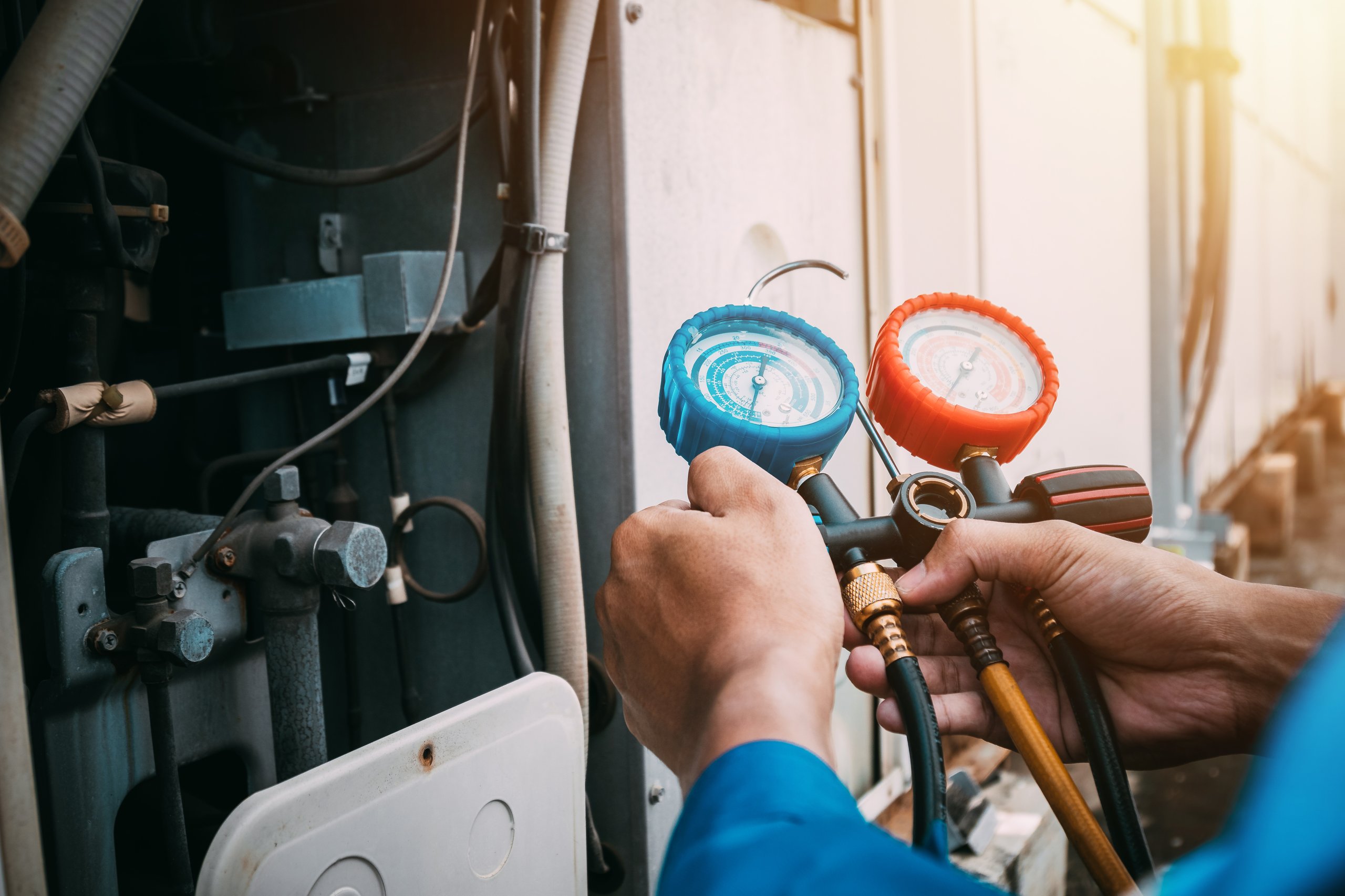 Technician checking air conditioning system for repair and maintenance